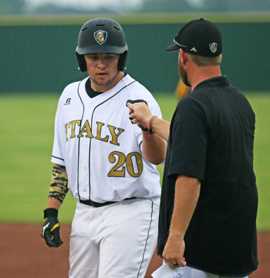 Image: Austin Crawford(20) receives that symbolic fist bump from assistant coach Mitchell Blake for a job well done after his team rallying single.