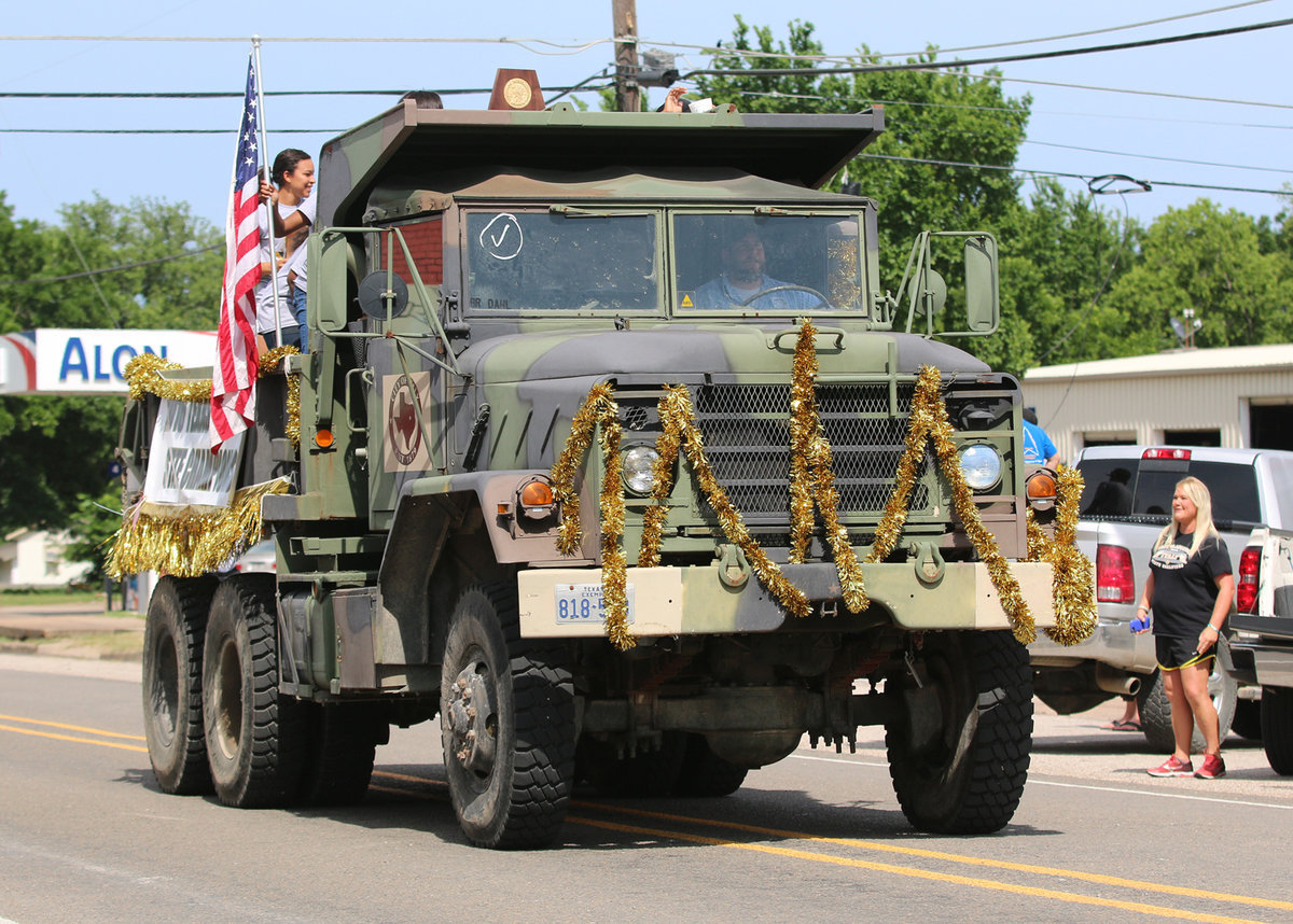 Image: Italy’s Lady Gladiator state champion track team rides in a camo painted “convertible” thru downtown Italy during the parade held in their honor.