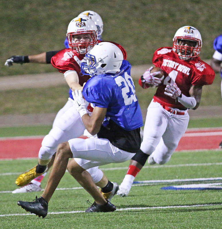 Image: Leading the way is Italy’s Clayton Miller(8) as the all-star receiver uses his blocking skills to help generate a big gain for the Red squad during the third-quarter.