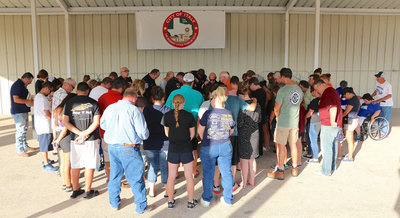 Image: First Baptist Church of Italy Pastor Ronnie Dabney leads Italy Police, Italy Fire, Milford Police Officers and citizens in a group prayer.
