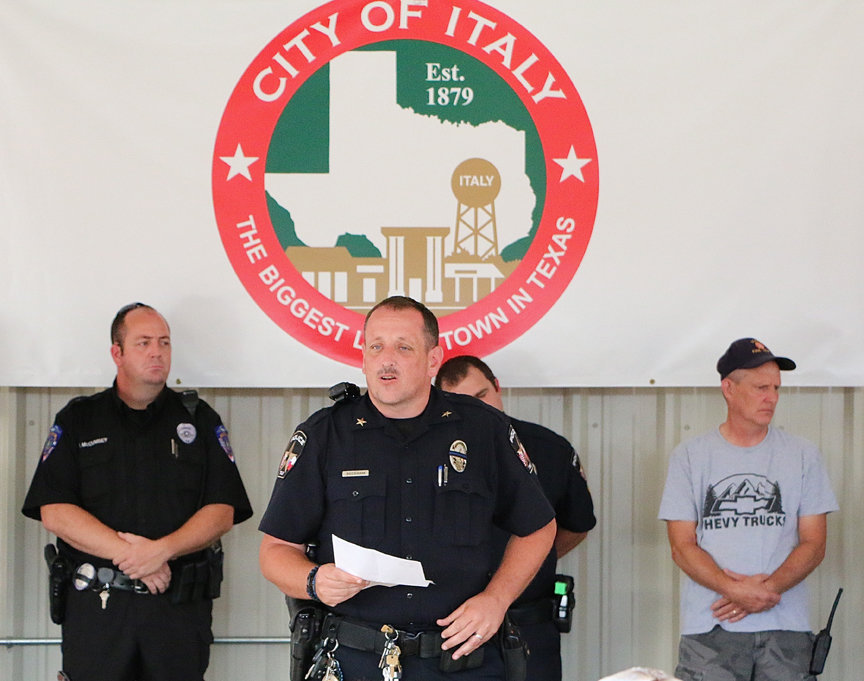 Image: Italy Police Chief Cameron Beckham reads a speech to those attending the prayer vigil held in downtown Italy following the recent attacks on Dallas Police Officers.