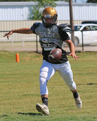 Image: Punter Gary Escamilla #8 takes a few practice reps.