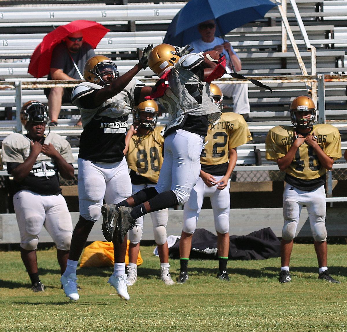 Image: Al Waits #21 picks off a pass on play 3 of the scrimmage for the Italy defense.