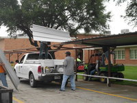 Image: Ken Cate and Brad Chambers attach the steel over the walkway.