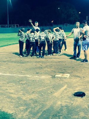 Image: Head Coach Gary Wood huddles up the team.