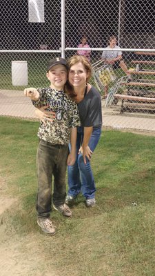 Image: Gared Wood displays his ring with mom Darla Wood after the tournament championship game.