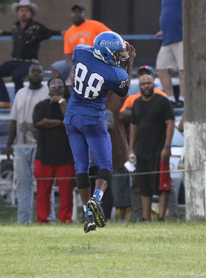 Image: Milford receiver #88 Markavion Thompson hauls in a pass from teammate Taron Smith.