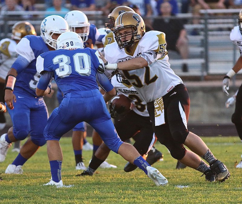 Image: Italy’s #52 James Walton helps clear some running room for the Gladiator backfield.