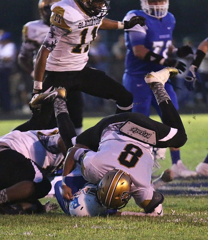 Image: Gladiator linebacker #8 Joe Celis drives a Lion running back into the turf.