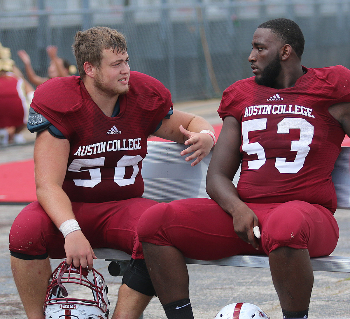 Image: Austin College nose guard #50 Zain Byers talks strategy with fellow defensive lineman #53 Jordan Keaton. Now juniors, both players have been Kangaroo teammates since their freshman year.