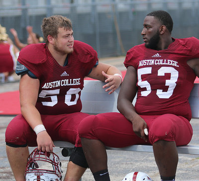 Image: Austin College nose guard #50 Zain Byers talks strategy with fellow defensive lineman #53 Jordan Keaton. Now juniors, both players have been Kangaroo teammates since their freshman year.