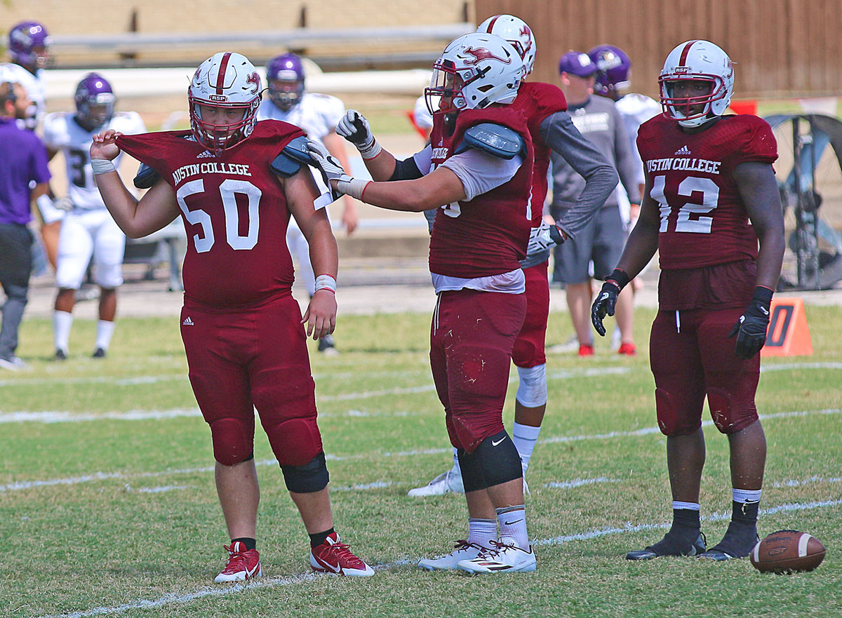 Image: It can be a tough job serving as the Austin College junior nose guard but junior ’Roo #50 Zain Byers gets some help from teammate #70 Don Ton, a junior tackle from Frisco. Also pictured is #42 Darlon Chandler, Dallas, Texas / Kathlyn Joy Gilliam.