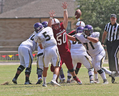 Image: Austin College Kangaroo nose guard #50 Zain Byers disrupts this pass attempt late in the fourth-quarter against the Whittier Poets.