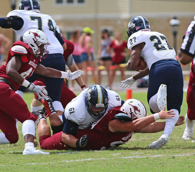 Image: Sacrificing for the cause is Austin College junior nose guard #50 Zain Byers who helped the Kangaroos hand Howard Payne a 19-17 loss.