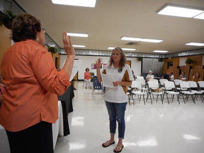 Image: Natasha Blackburn administers the Oath of Office for newly appointed Board member Cortney Janek.