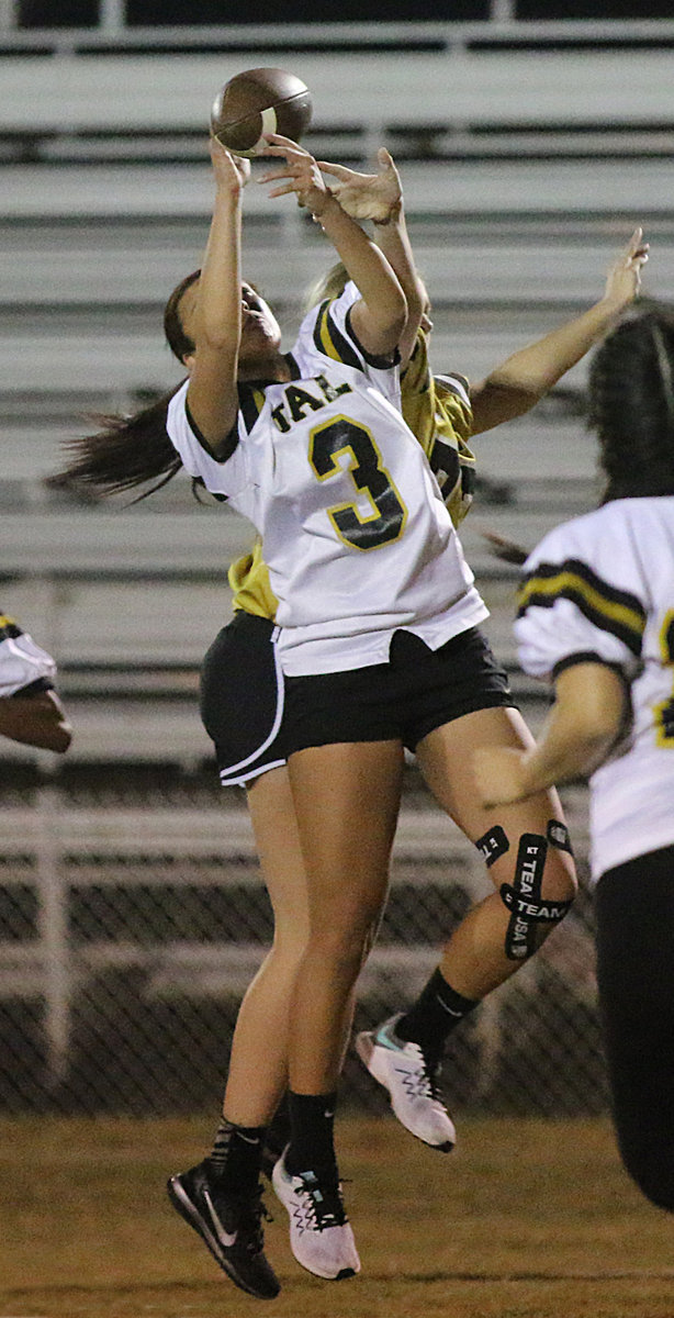 Image: Senior defender April Lusk keeps junior receiver Annie Perry from making the catch.