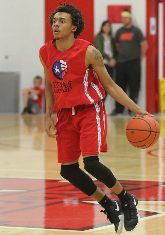 Image: Italy’s Keith Davis II uses his fancy moves and dribbling skills to get up a shot.